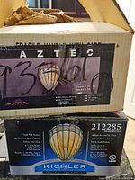 Boxes showing model and brand info of the pair of Tiffany style wall sconces.