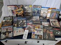 Full lot displayed on white cloth including DVDs and Blu-rays of movies starring Chris Evans, Jeremy Renner, Benedict Cumberbatch, and Tom Hiddleston