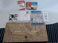 Photo showing various Canadian collectible items including stamp books and coin display case on a white background.