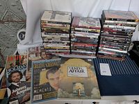 Stacks of DVDs in drama and thriller genres alongside various magazines and a press booklet