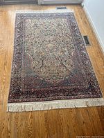 Full view of rectangular rug laid flat on hardwood floor