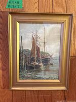 Full view of antique watercolour painting in gold frame hanging on a wood panel wall. A green tag shows painting measurement labels.