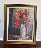 Full view of the framed oil painting showing the floral still life artwork with gold and cream frame.