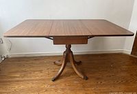 Table fully extended with both drop leaves raised