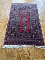 Full view of the rectangular Turkish wool rug showing its overall pattern, colors, and fringe.