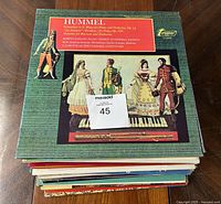 Stack of 38 LP albums showing the outer cover of the top album featuring Hummel music with classical artwork and text