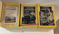 Stack of 99 National Geographic magazines featuring yellow border covers with various photographic fronts showing wildlife and historic images from 1960 to 1969.