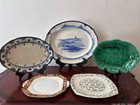 Group shot of all five platters and plates arranged on a table showing various sizes, shapes, and floral designs.