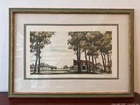 Framed landscape print showing trees, building, and path with figures.