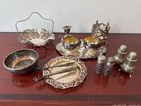 All 13 pieces arranged on wooden surface showing full lot contents including reticulated bonbon dishes, salt and pepper sets, tongs, bowl, and candle holder