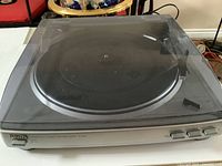 AIWA PX-E860 turntable with closed dust cover, showing front buttons and overall condition.