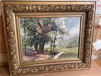 Front view of the antique framed print showing landscape image and ornate gold frame.