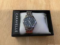 Full view of the Caravelle ladies watch in its original black box with pillow cushion, showing brand on box side.