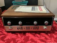 Front view of amplifier on red tablecloth
