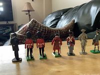 Nine painted lead soldiers and an Abraham Lincoln figurine displayed on the table, showing a variety of uniforms from different angles.