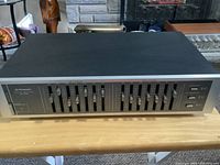 Front view of Pioneer SG-550 graphic equalizer showing multiple frequency slider controls and power buttons.