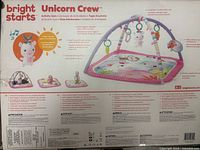 Back of the packaging showing brand, product name, and details about features such as hanging toys and ways to play.
