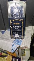 Front of the tin packaging showing Helix Oxford branding and product name.