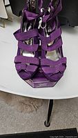 Front view of the purple suede shoes showing multiple straps and open toe design.