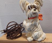 Front view of the ceramic dog lamp with power cord visible