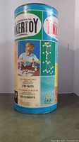 Side view of the vintage 1972 Original Tinkertoy Master Builder set metal container, showing branding and part count of 250 elements.