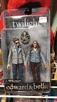 Photo of unopened Twilight Edward and Bella action figures in original packaging showing detailed figures and packaging design.