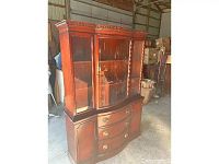 Front view of the Drexel mahogany bow front china cabinet with glass display doors and brass handles, showing overall design and condition.