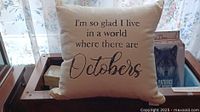 Front view of cream or off-white decorative pillow displaying fall-themed quote.