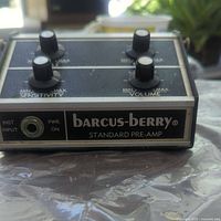 Front angle showing instrument input, power indicator, and sensitivity and volume knobs.