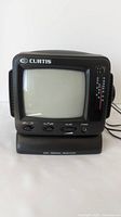 Curtis RT064 portable B&W TV front view showing the screen, controls, and headphone jack.