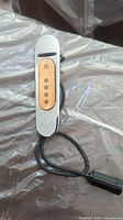 Full view of vintage DeArmond Fender guitar pickup with cable on metallic surface.