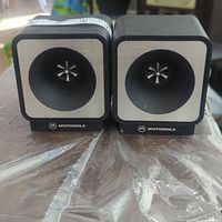 Front view of both Motorola mini speakers showing cube shape and central speaker grille design.