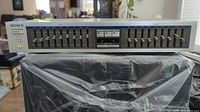Front view of the Sony SEQ-9 graphic equalizer showing all frequency sliders and power button.