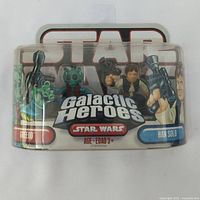 Front view of Star Wars Galactic Heroes packaging showing both Han Solo and Greedo figures inside clear blister pack with branding and age recommendation.
