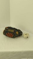 Wilson Tom Henske XL men's left hand baseball glove and Cooper softball on white surface