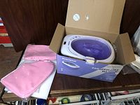 Beau Wink Paraffin Wax Machine boxed with pink mitts and foot covers on shelf