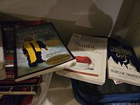 Display of several Christmas-themed magazines and books including 'Christmas Jokes', 'Santa Secrets', and 'The Christmas Gift'.