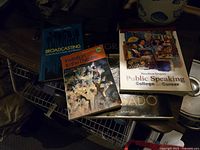 Four books on broadcasting, theatre, and public speaking arranged on a white surface showing covers.