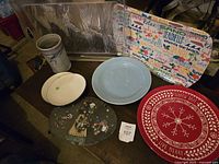 Full overhead view of all items including plates, pottery, trays and Christmas slate decoration on wooden surface