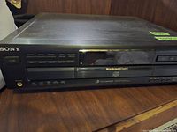 Front view of Sony MegaStorage 5-CD changer player showing disc tray, control buttons, and headphone jack