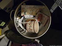 Top view of 34-quart stainless steel stock pot containing smaller crock pots and recipe books arranged inside.