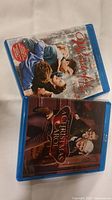Photo showing both Blu-ray cases for the movies 'A Christmas Carol' and 'It's A Wonderful Life' lying on a white surface.