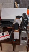 Full lot showing all electronics including Panasonic stereo system, speakers, router, DVD player, and cables