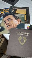 Spread of vinyl record covers including Johnny Cash 'At Folsom Prison', Jesus Christ Superstar, and others