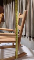 Side profile of one wooden rocking chair showing seat height approximately 23 inches