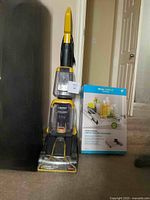 Photo showing Bissell TurboClean PowerBrush Pet Carpet Cleaner upright model next to the boxed under cabinet sliding shelf.