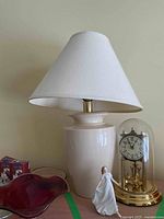 Image showing the lamp, Royal Doulton figurine, and Kundo anniversary clock in a row on a wooden surface.