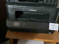 Canon Pixma MX922 Printer showing front control panel with digital display and buttons, highlighting the printer's condition and model.
