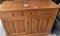 Photo showing front view of the matching top hutch piece with similar wood and knob design.