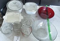 Photo of CorningWare and various glass bowls, measuring cup arranged on flat surface